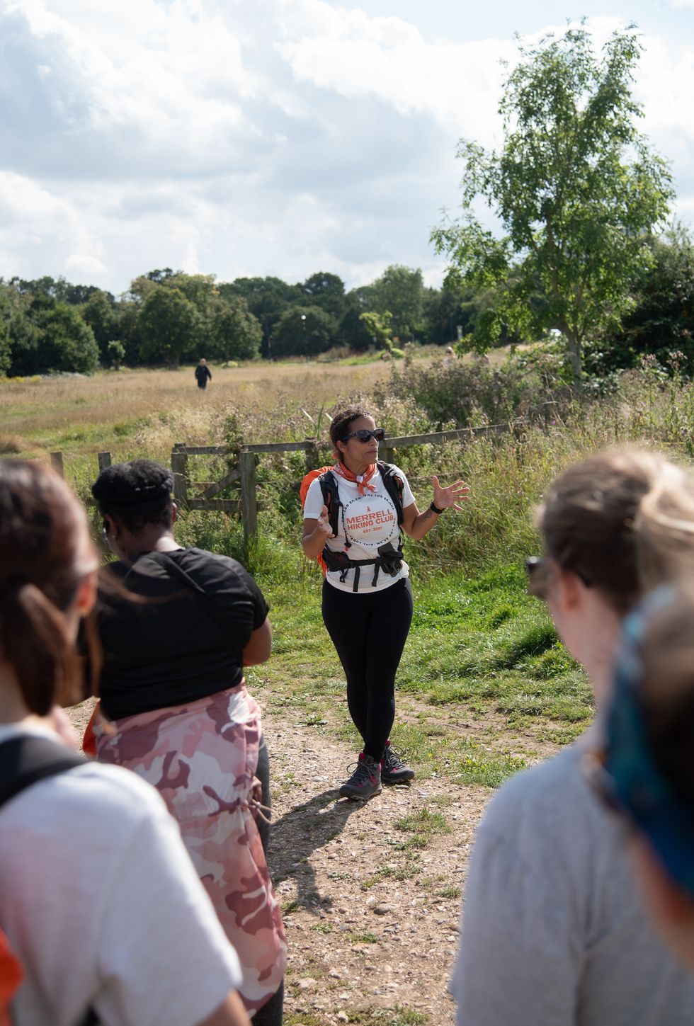 Woman speaking to a group of people and looking to the side
