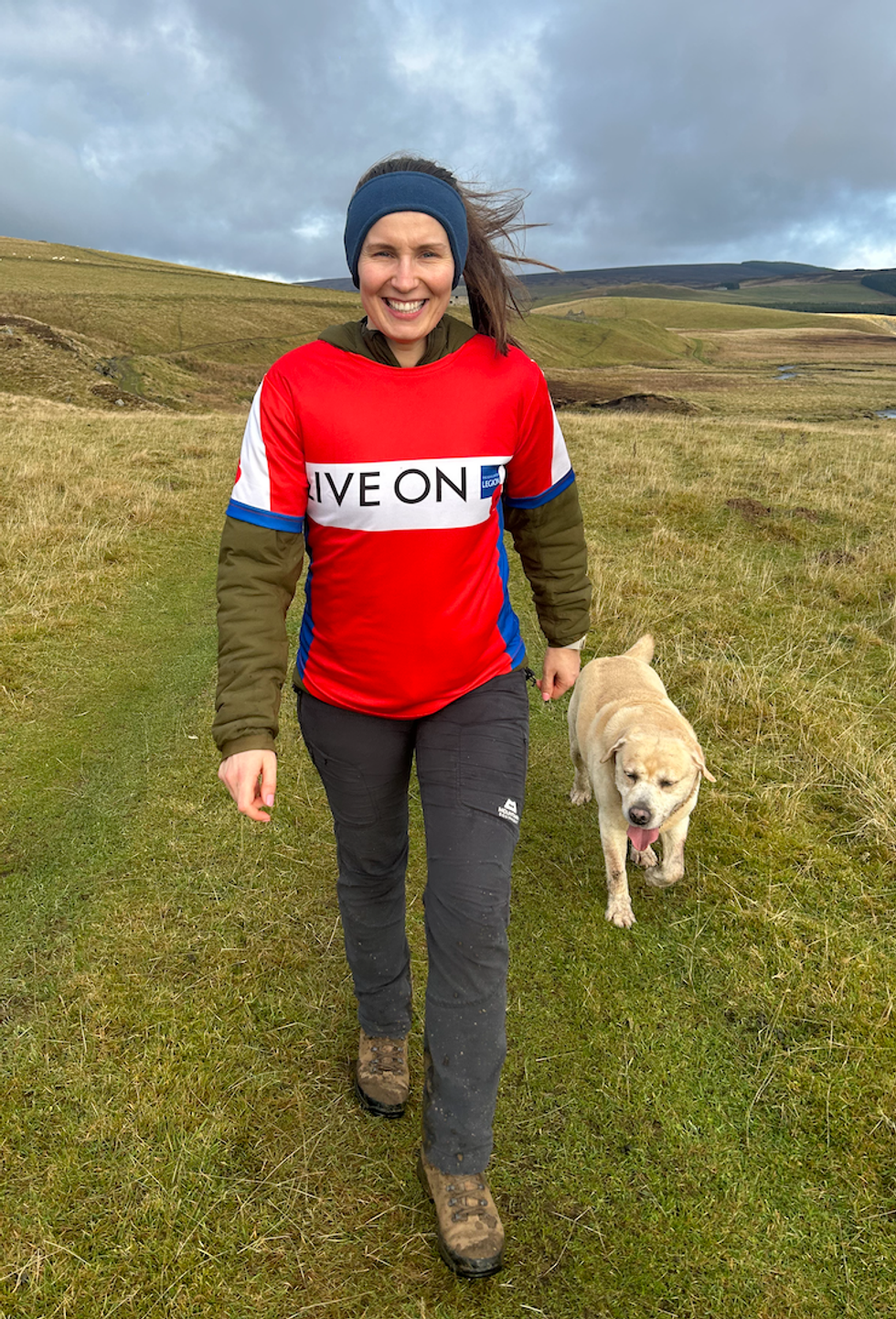 Woman walking with dog next to her