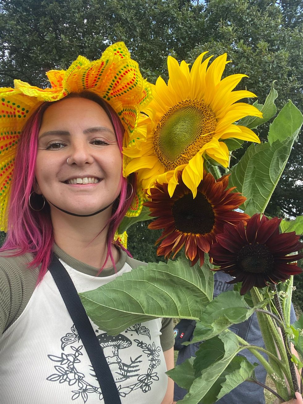 Woman with a sunflower next to her