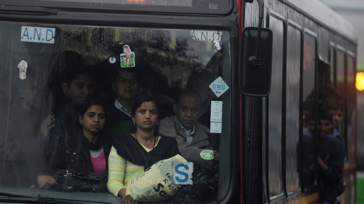 Women travel on a bus in New Delhi