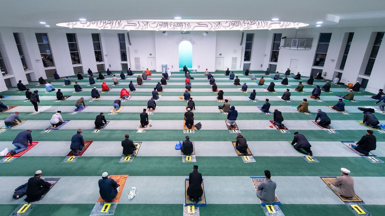 <p>Worshippers observe social distancing at the Baitul Futuh Mosque, in Morden, south west London, on the final day of Ramadan</p>