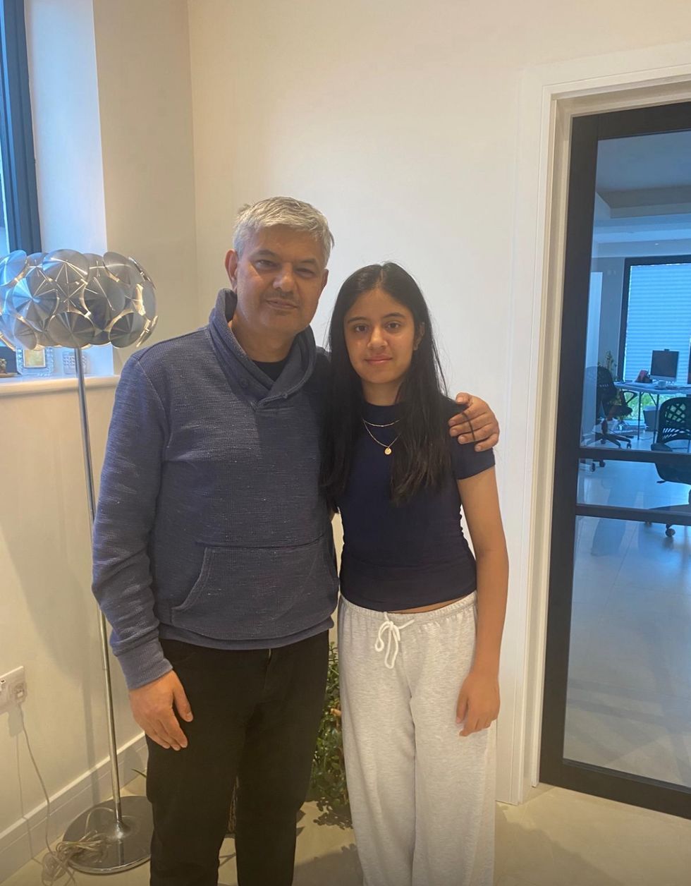 Yogesh Jethani with his arm round his daughter Kyra