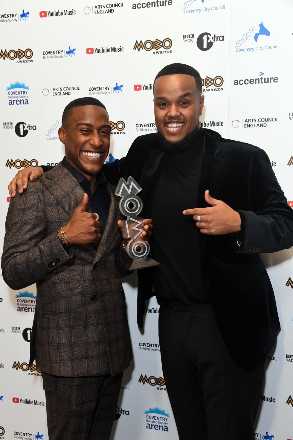 Yung Filly and Chunkz pose with the 'Best Media Personality' award in the media room at the MOBO Awards 2021 at The Coventry Building Society Arena on December 05, 2021 in Coventry, England